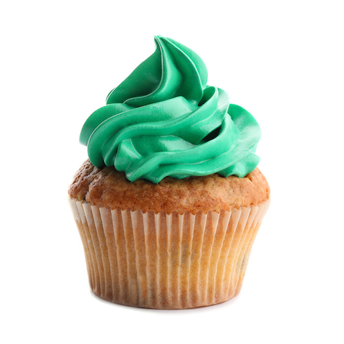 cupcake with green frosting on white background